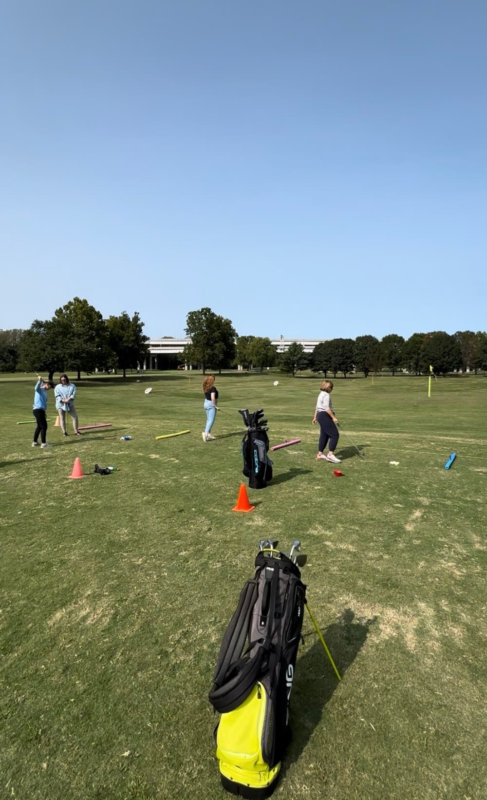 A group golf lesson on the driving range